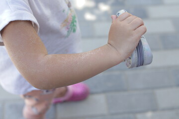 sunburn on the shoulder of a child, after a long time in the sun, the concept of skin protection.