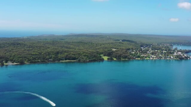 Aerial panorama of Lake Macquarie waterfront at Murrays beach resort as 4k.
