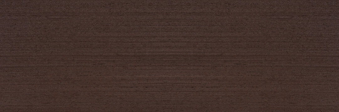 Texture of wenge wood. Dark brown wenge background. Natural brown wood texture, solid natural wood for furniture production
