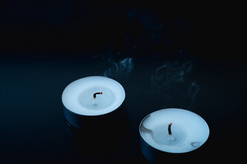 an extinguished candle, smoke from a fading overhang