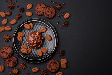 Obraz na płótnie Canvas Delicious chocolate tart with nuts on a black ceramic plate