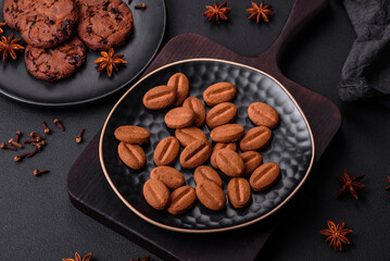 Delicious chocolate cookies with nuts on a black ceramic plate