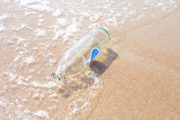 Fototapeta na wymiar Glass bottle on the beach