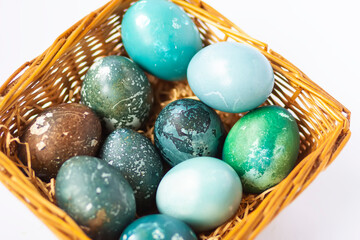 Colorful Easter eggs in a basket. Traditional festive decor.