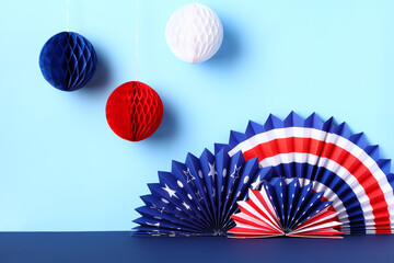 American paper fans and decorations on a blue background. Banner design for President's Day, Independence Day and other US national holidays. - obrazy, fototapety, plakaty