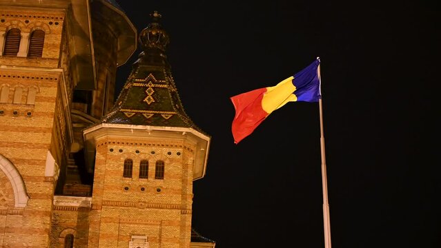 Romanian flag by Orthodox Metropolitan Cathedral in Timisoara, Romania. Flag of Romania. 