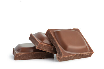 Pieces of milk chocolate on a white background