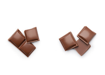 Pieces of milk chocolate on a white background