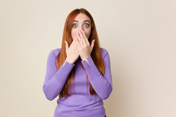 Young red hair woman isolated shocked, covering mouth with hands, anxious to discover something new.