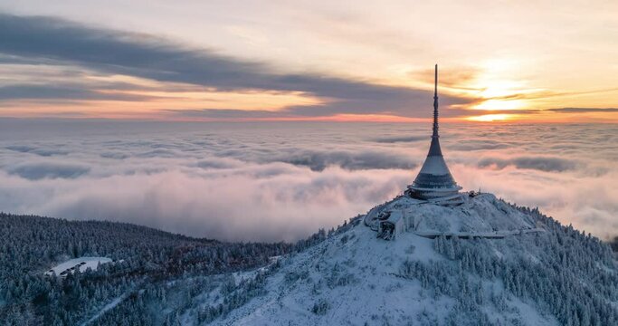 Jested tower hyperlapse mountain hill with snow mist and fog at golden hour