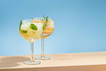Mojito with lemon and mint on blue background
