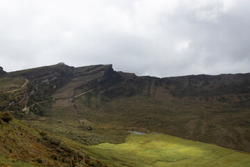 Beautiful colombian paramo ecosystem landscape with andean mountain range at background and a green valley