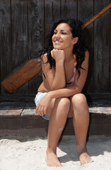 Fototapeta premium young woman on the beach near some canoes