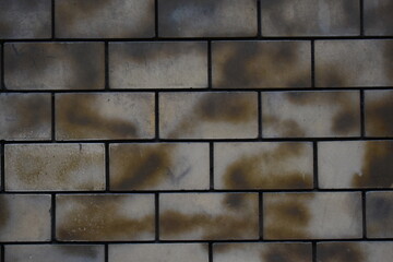 Old brick wall with a golden abstract spray detail background 