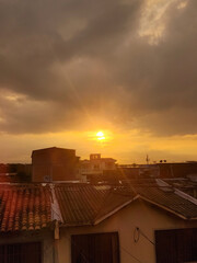 sunrise in city with buildings and sun in the background