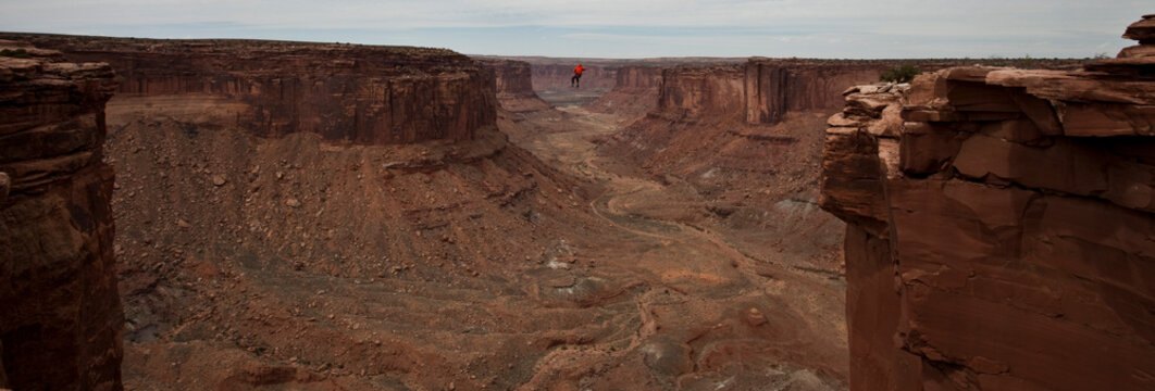 Andy Lewis tapes a world record highline, three hundred and forty feet long, at the Fruit Bowl in Moab, Utah, USA.