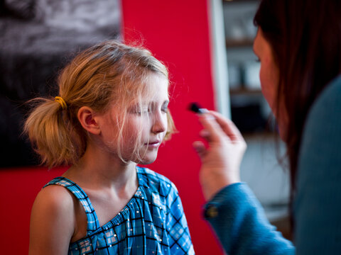 young girl experiments with make up