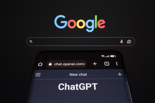 ChatGPT chat bot page seen on smartphone and laptop display with blurred GOOGLE search page. AI chatbot vs search engine. Concept. Stafford, United Kingdom, January 29, 2023