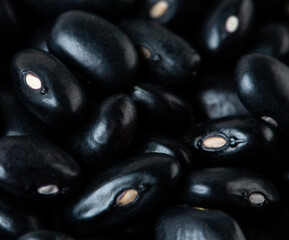 Macro Close up Texture of black bean, round grain beans. Beautiful complete seed pea bean, food object design. Selective focus freeze shot black background isolated