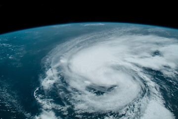 Hurricane from space, satellite view. Hurricane catastrophe. Elements of this image furnished by NASA. Selective focus. Noise and grain included.