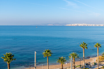 Aerial view of the Palaio Faliro waterfront promenade and park with the city of Piraeus Greece in view across the bay, at Palaio Faliro, Greece.