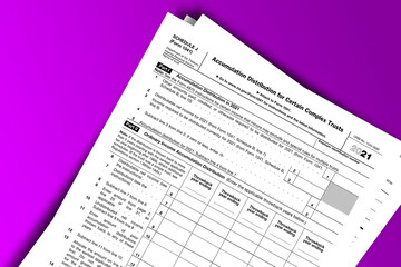 Form 1041 (Schedule J) documentation published IRS USA 10.27.2021. American tax document on colored