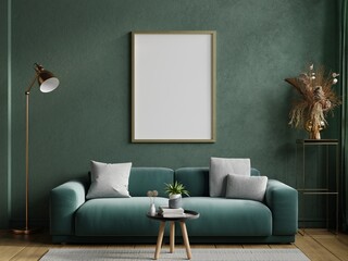 Poster mockup with vertical frame on empty dark green wall with green velvet sofa.