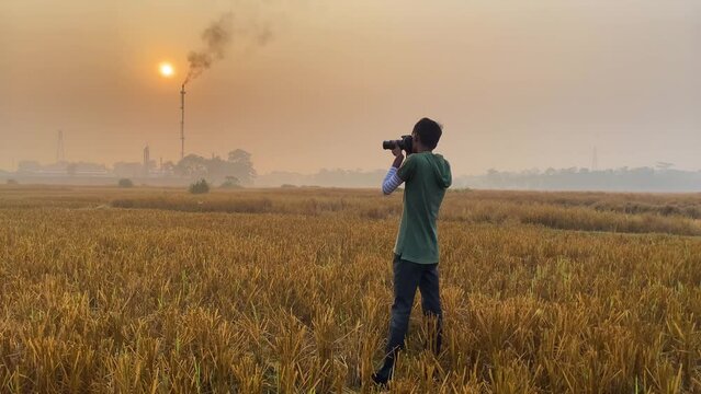 Cinematic view of photographer taking pictures of polluting industrial area