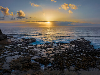 Sunrise over the ocean and rock platform