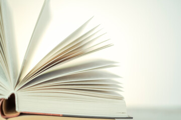 Learning and knowledge symbol.Reading and education. Open books on a light background with a yellow gradient.stack of books on a wooden tableLiterature and reading concept.