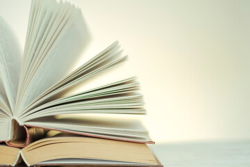 Reading and education. Open books on a light background with a yellow gradient.stack of books on a wooden table.Learning and knowledge symbol.Literature and reading concept. 