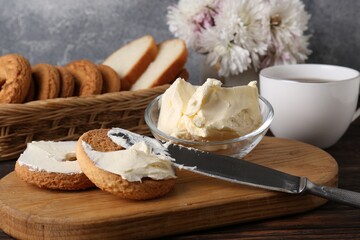 Tasty homemade butter, cookies and cup of tea on wooden table, closeup
