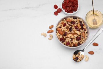 Tasty granola with nuts and dry fruits on white marble table, flat lay. Space for text