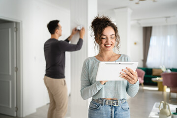 man and woman couple wife husband set up surveillance security camera