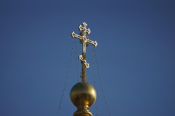 Fototapeta na wymiar golden cross on blue sky