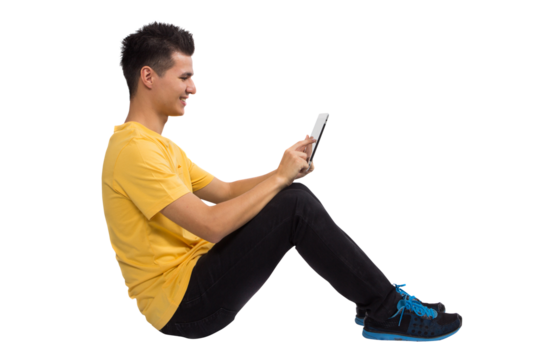 Full body Teenage boy portrait sitting using tablet computer - Powered by Adobe