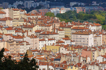 Fototapeta na wymiar Older buildings and chimneys gradually give way to more modern structures up the hill in Lyon, France