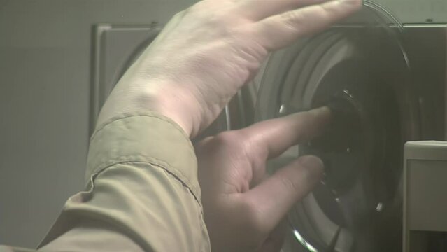 Hands of a Man Using an Old Reel-to-reel Audio Tape Recorder. Close Up.  