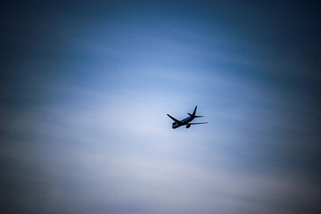 Fototapeta na wymiar Air plane fly in the blue sky in summer