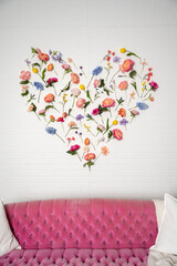 Landscape of flowers spread on a wall in the shape of a heart