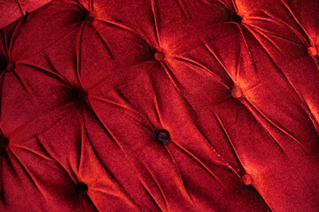 Bright red velvet sofa seat with tufts