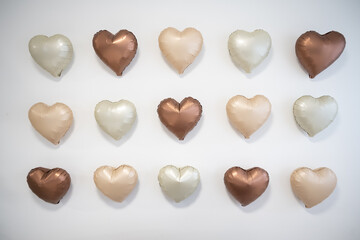 Wall of neutral colored heart shaped balloons
