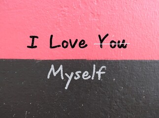 Gray and pink background with chalk handwritten text I LOVE YOU (cross out you) MYSELF, concept of...