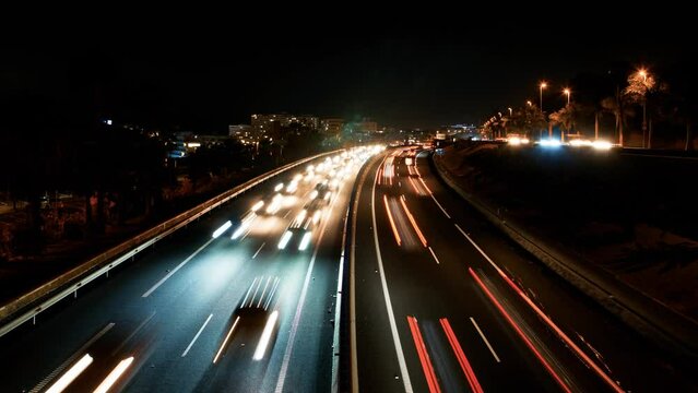 Beautiful timelapse of the TF-1 highway on Las Americas (Tenerife, Spain) at night, rush hour traffic jam, light streaks, wide shot