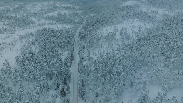 Drone shot of EV Opel Ampera driving in beautiful big snowy landscape in Norway.