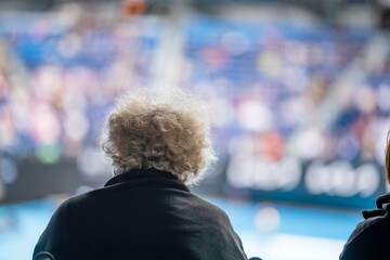 elderly tennis fan watching a farm in a wheelchair at the australian open