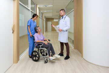 Young caucasian doctor in white gown inform the good news of the test result to asian senior patient in a wheelchair. Healthcare and medicine concept.
