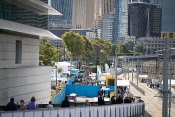 tennis fan watching a tennis match at the australian open eating food and drinking