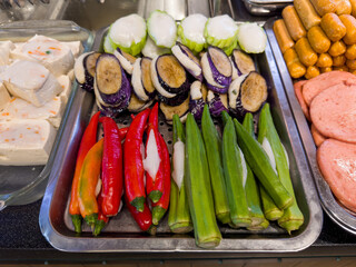 Various steamboat ready to cook ingredient display in hawker stall.