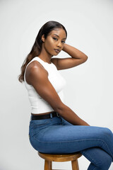 model in neutral clothing in front of white photography backdrop background modeling black african american dark complexion beautiful gorgeous jeans white top digitals headshots recruitment